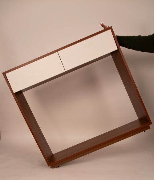 Modern wooden console table with white drawers shown in tilted view by RISA