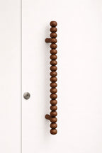 round-bead-wooden-handle-detail-shot
modern-wardrobe-handle-close-up-design
designer-wooden-handle-detail