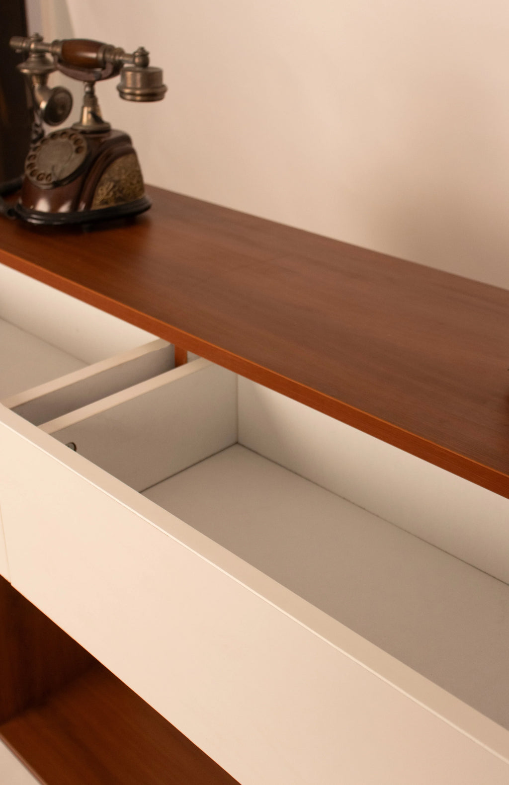 Close-up of open drawer storage in modern wooden console table by RISA
