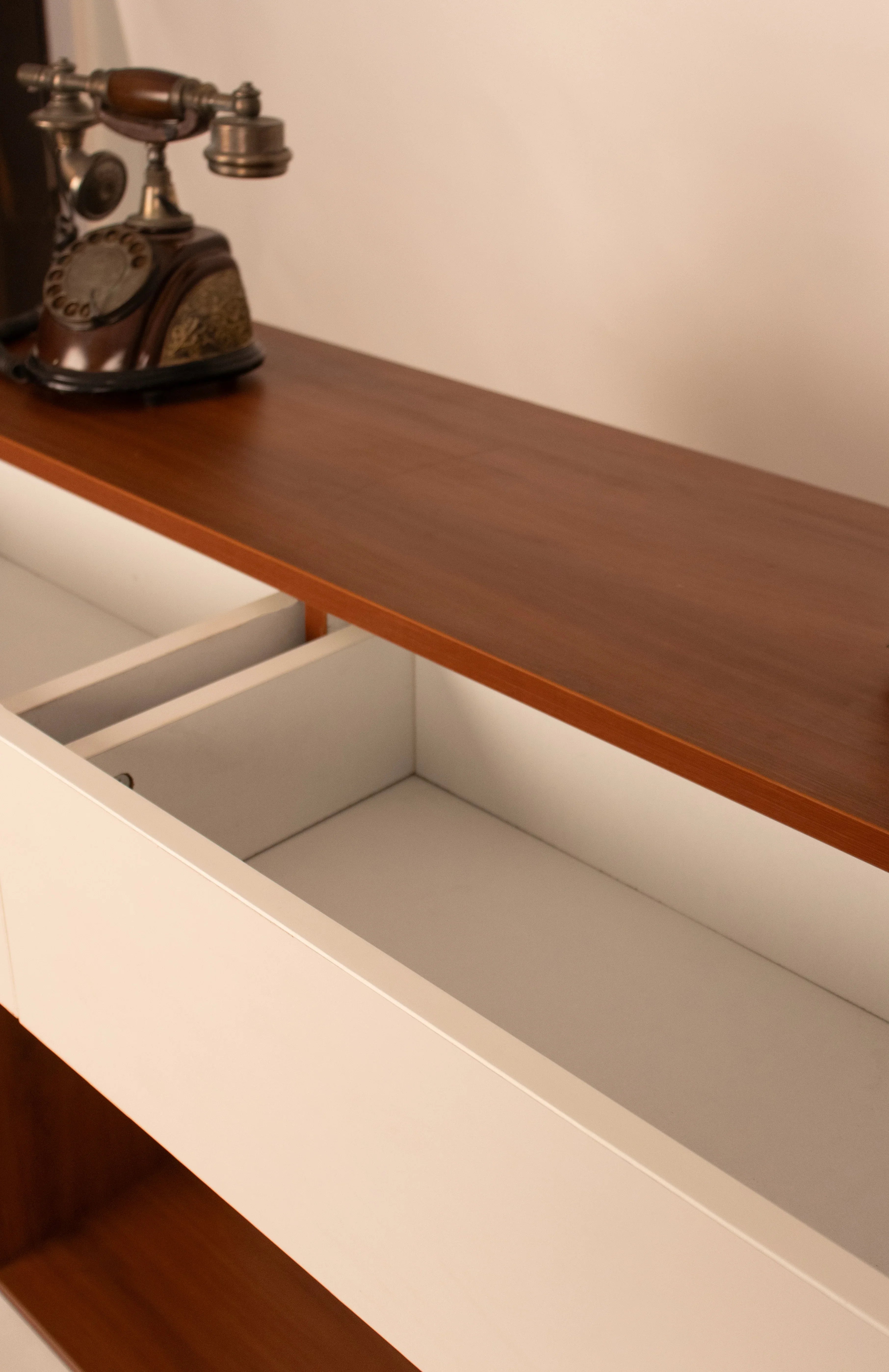 Close-up of open drawer storage in modern wooden console table by RISA