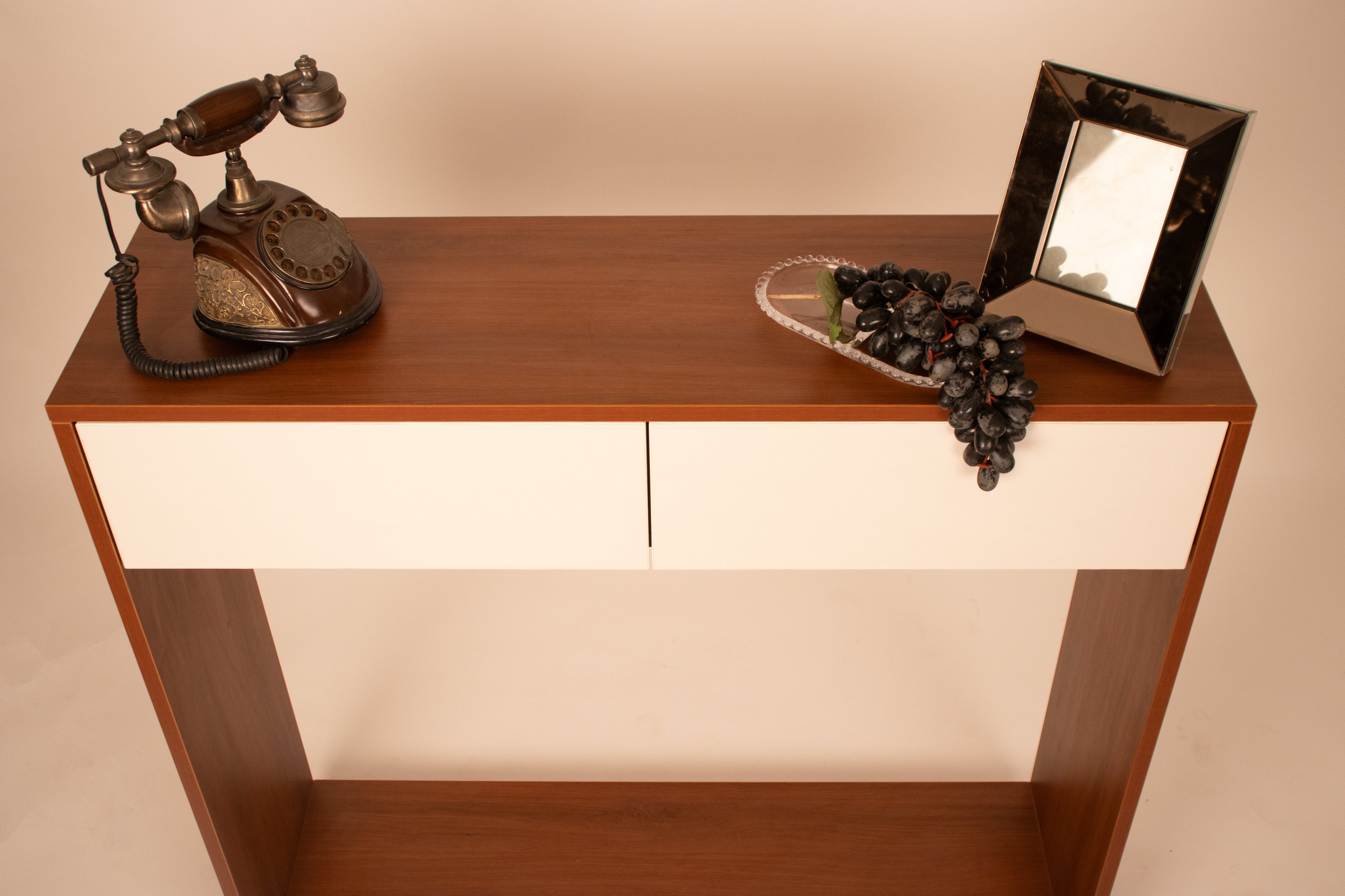 Modern wooden console table with white drawers styled with vintage decor by RISA